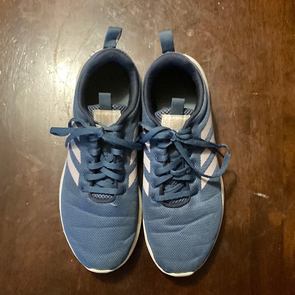 Dusty blue adidas sneakers with lavender stripes.